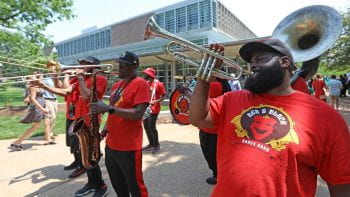 A brass band plays in front of Olin Library.